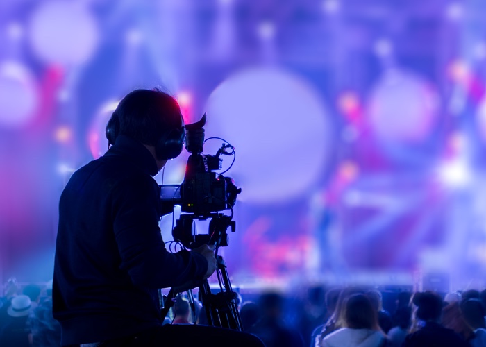 Camera man video recording a large event