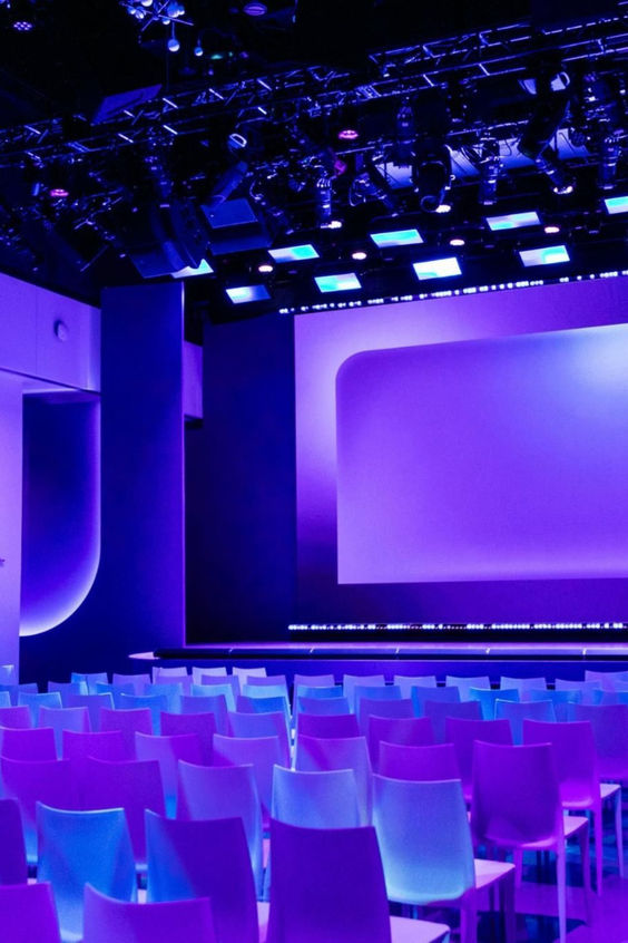 Auditorium lit up with purple and blue lights