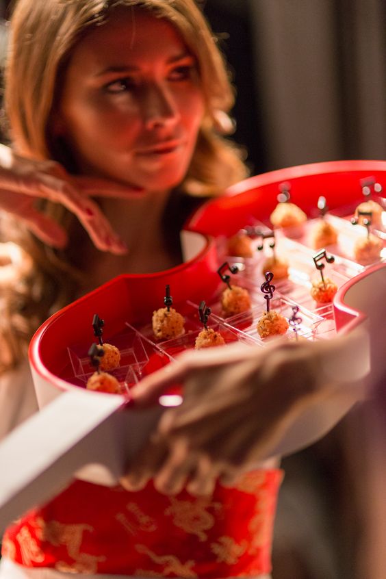 Woman holding a tray of candies