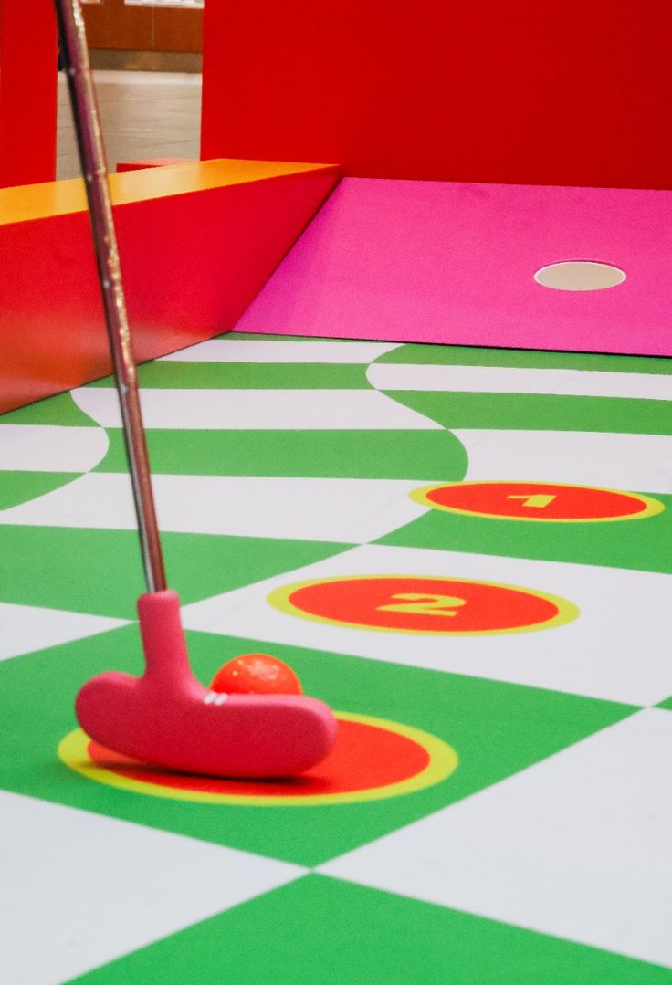 Mini golf club putting a golf ball